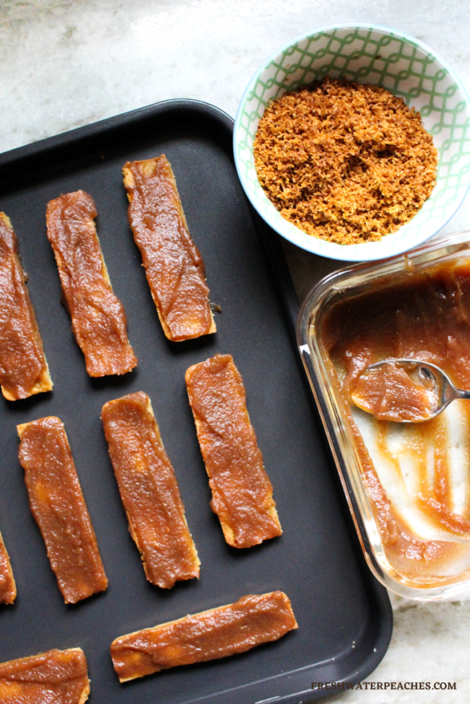 candy bars with first layer of caramel sauce.