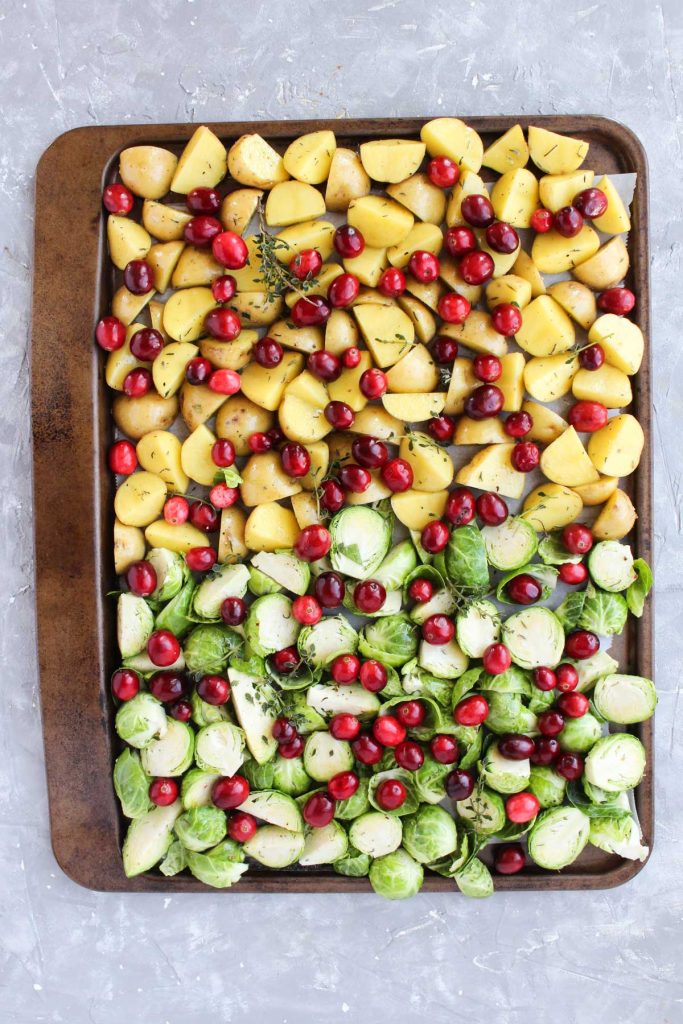 Fall vegetables on the sheet pan before being roasted.