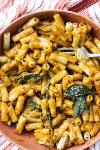 Big bowl of pasta tossed in roasted tomato sauce.