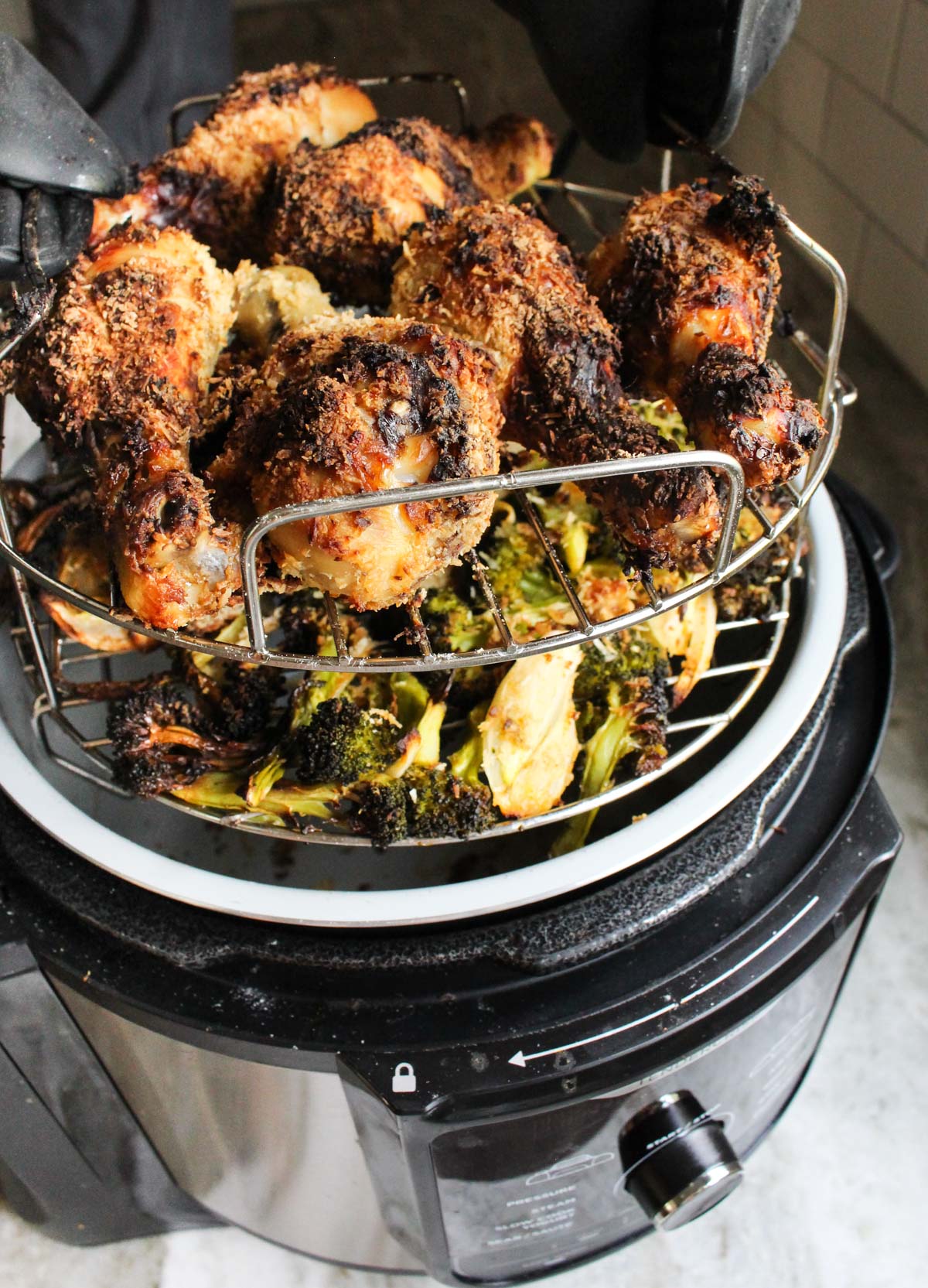 Removing chicken from the air fryer.