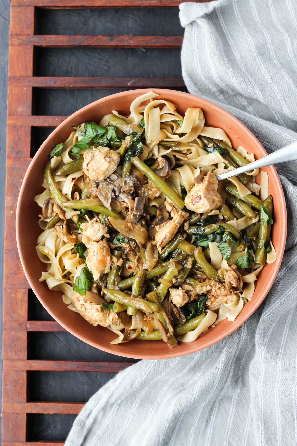 Overhead shot of large bowl filled with balsamic mushroom dinner over fettuccine.