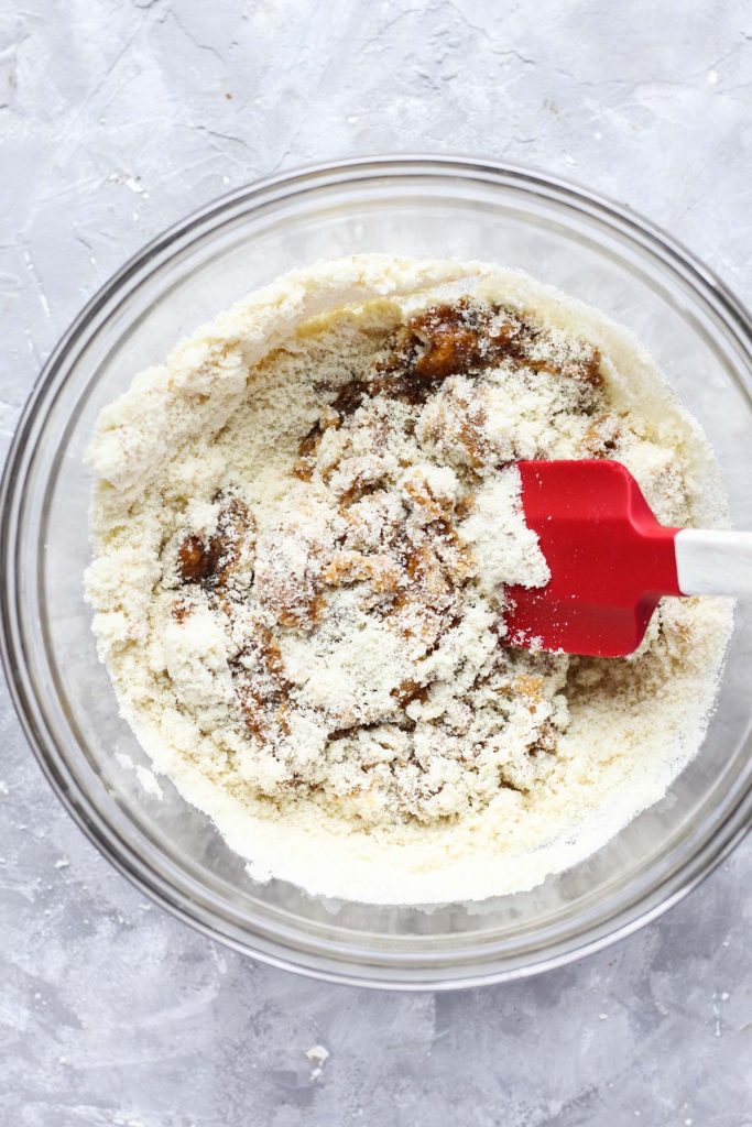 Folding dry ingredients and wet ingredients together.