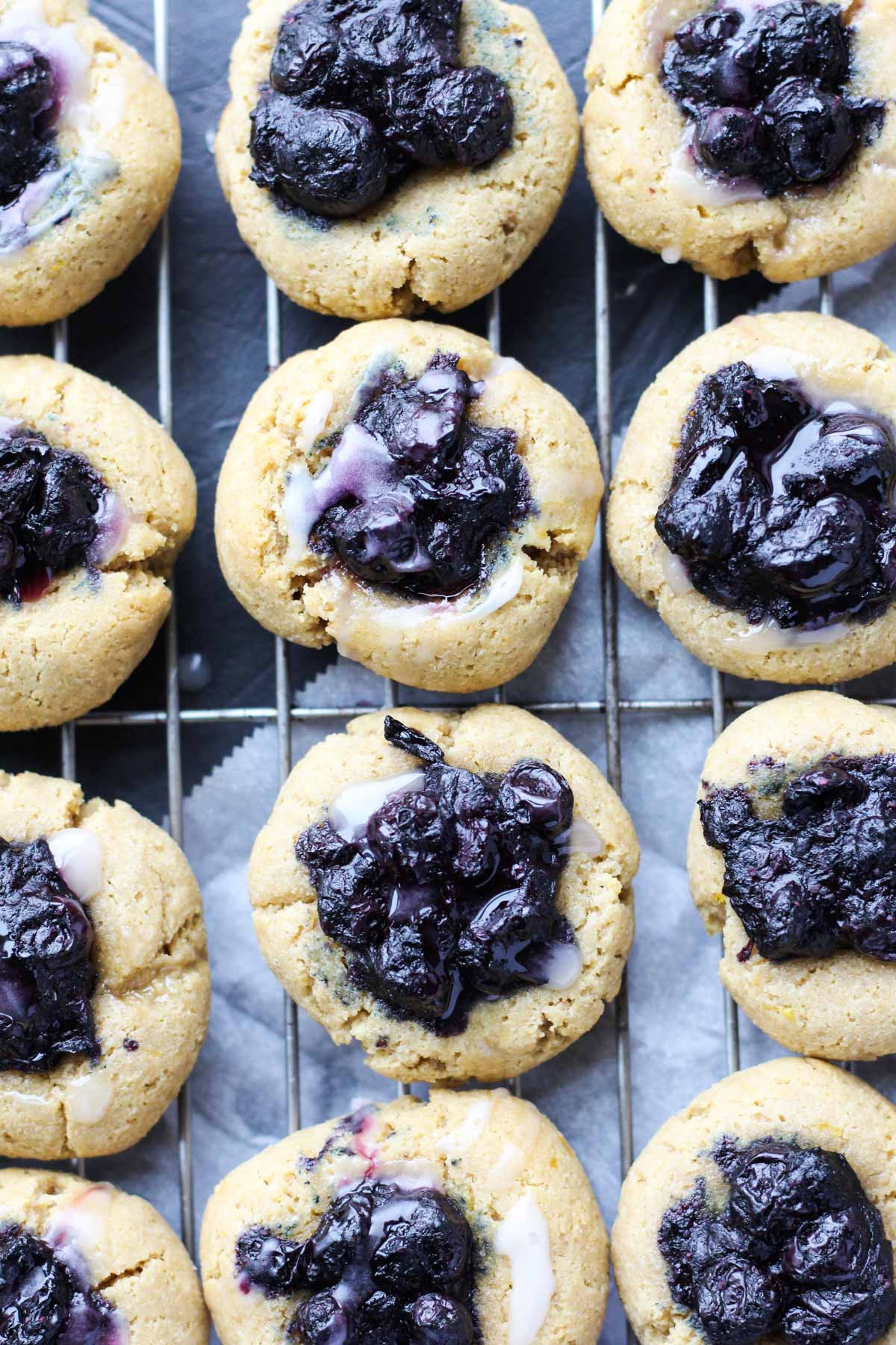 Lemon blueberry thumbprint cookies  cooling on a metal rack.