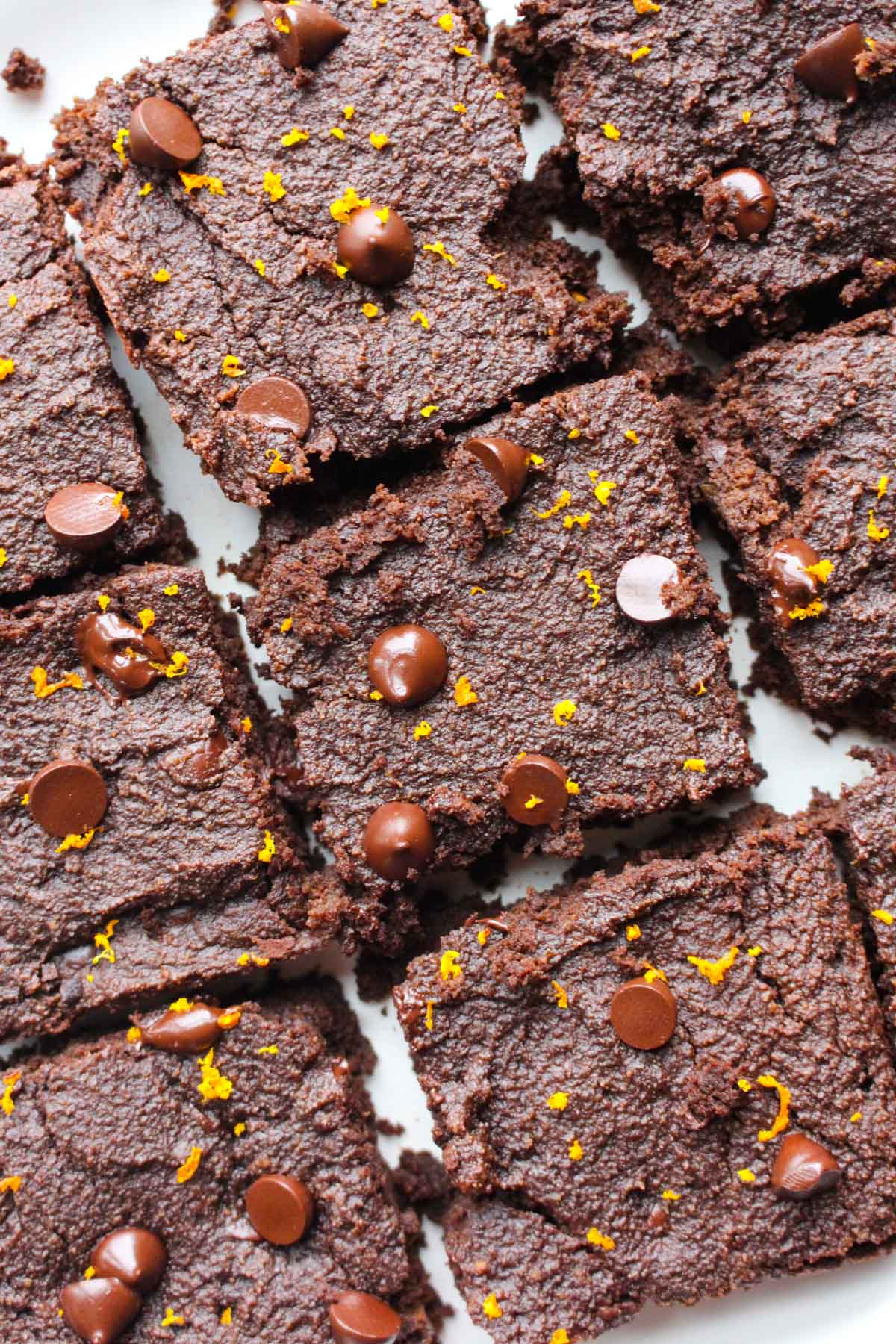 Overhead shot of brownies with orange zest on top.