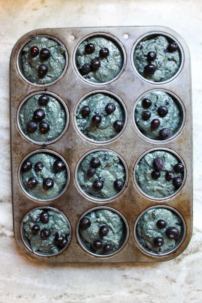 Muffins in muffin tin before baked.