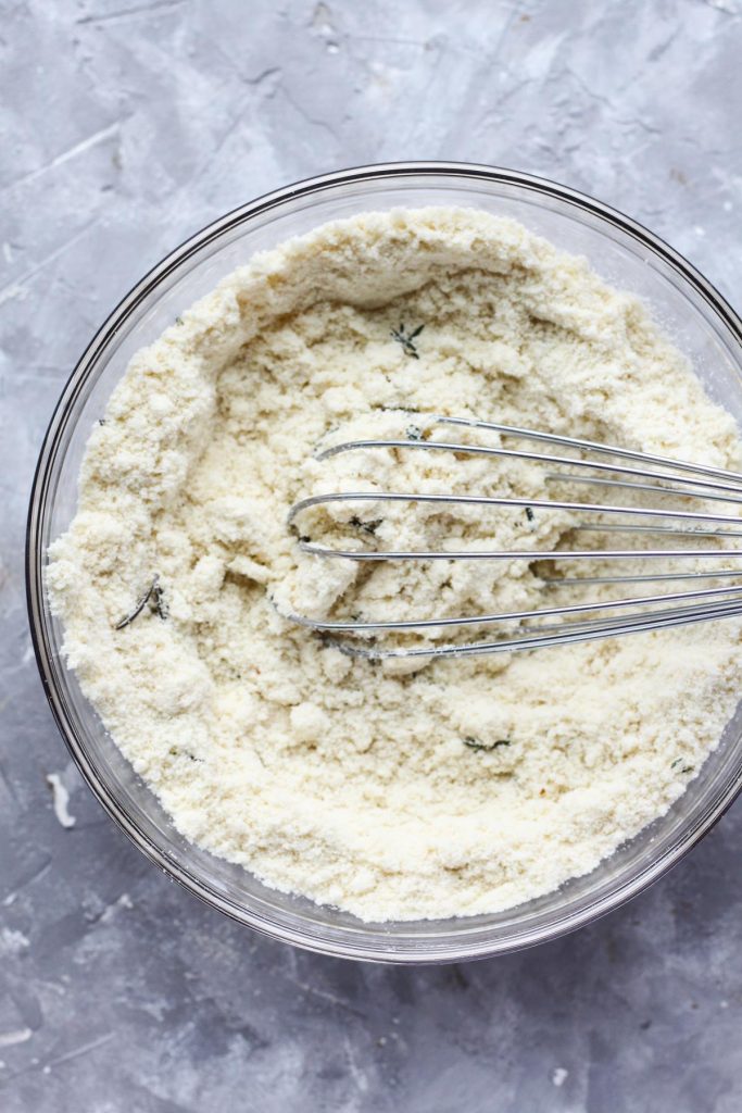 Dry ingredients in a mixing bowl with a whisk.
