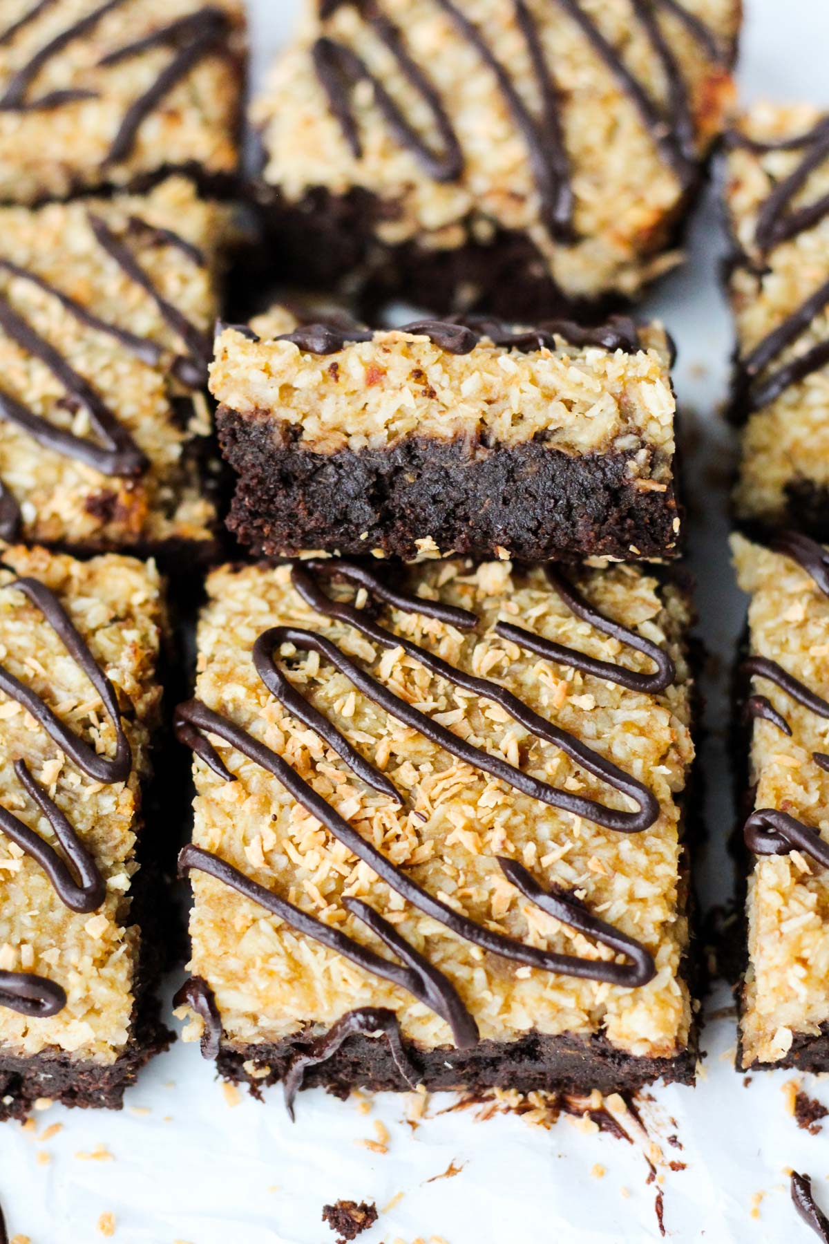 Brownies lined up with one stacked on top so you can see the thick, rich chocolate brownie.