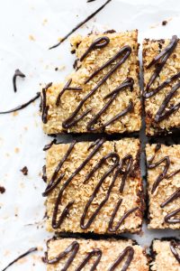 Overhead shot of gluten free samoa brownies with chocolate swirl on top.