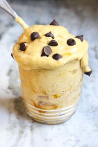 Pumpkin ice cream in a mason jar with chocolate chips on top.