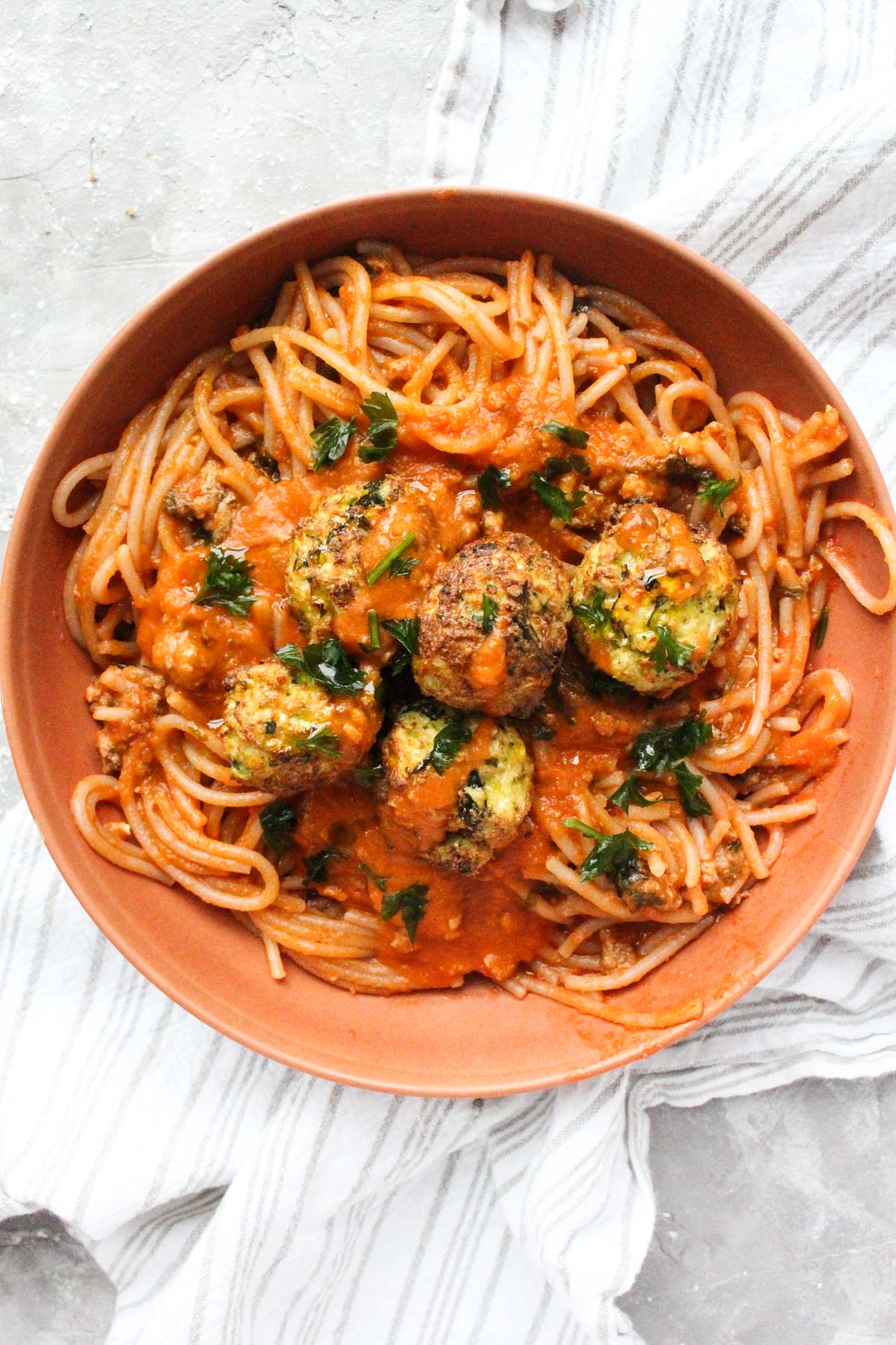 Meatballs and sauce over spaghetti.