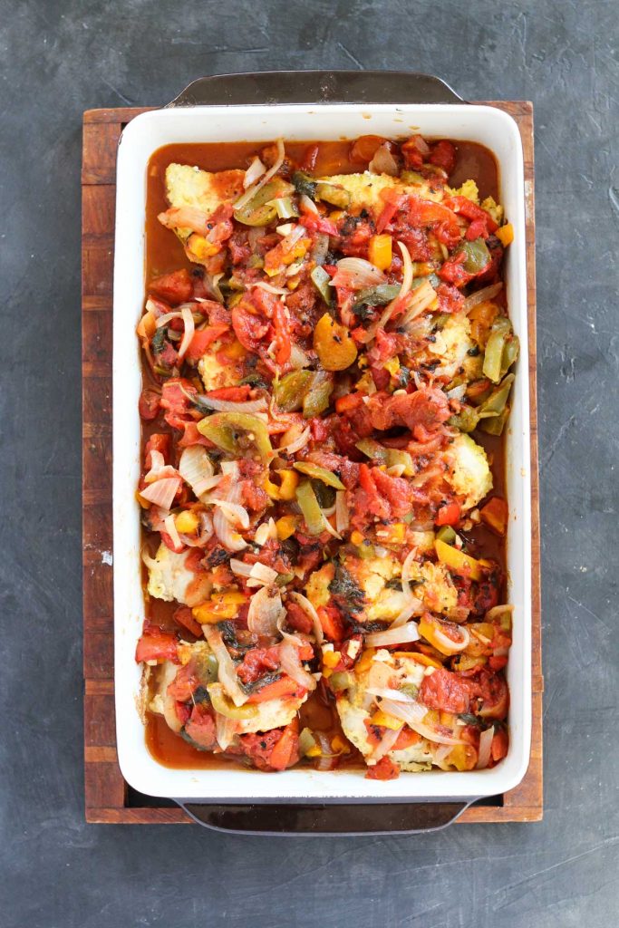 Sauce on top of chicken in baking pan.