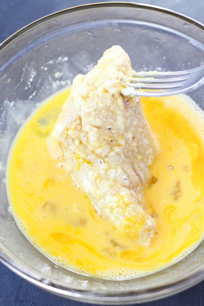 Chicken back in egg wash.
