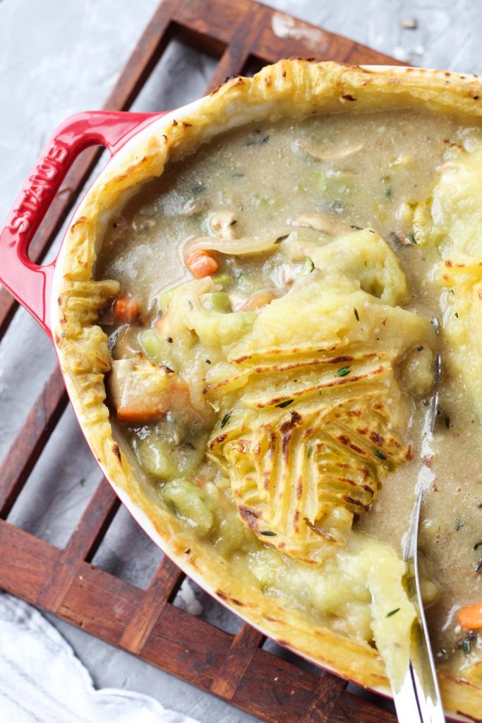 Spoon scooping out chicken pot pie.