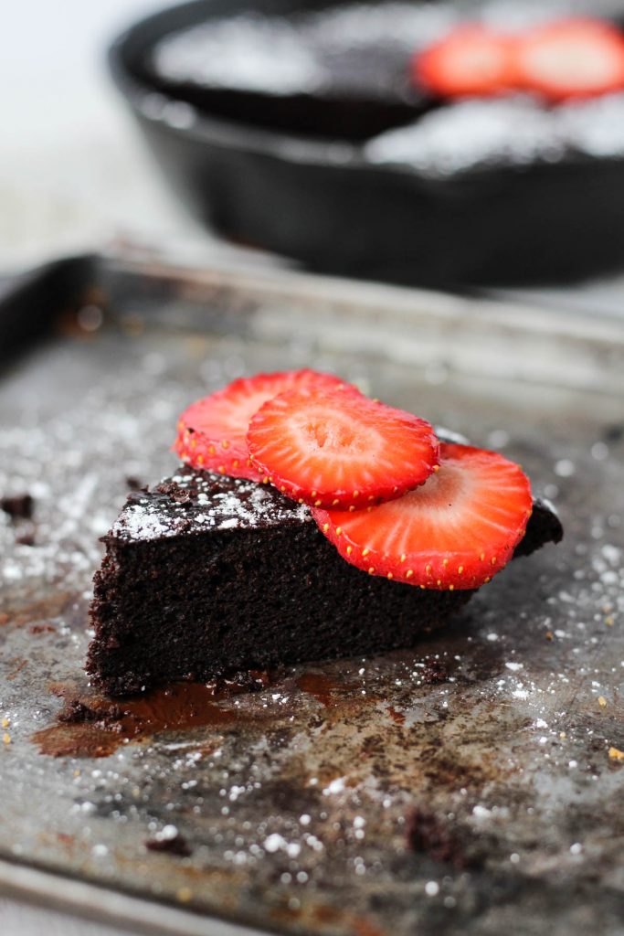 Cake slice with strawberries on top.