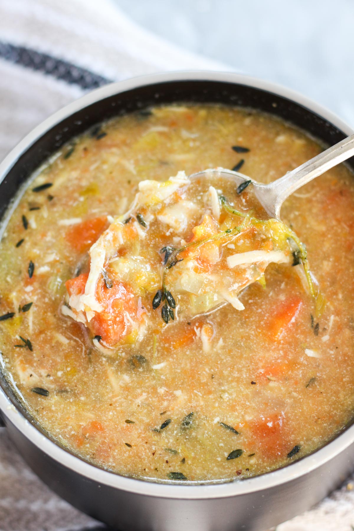 Close up shot of large spoonful of soup.