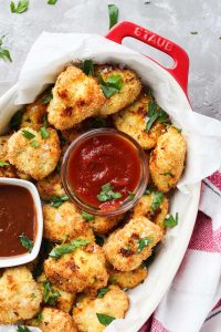 Overhead shot of chicken nuggets with ketchup and bbq sauce.