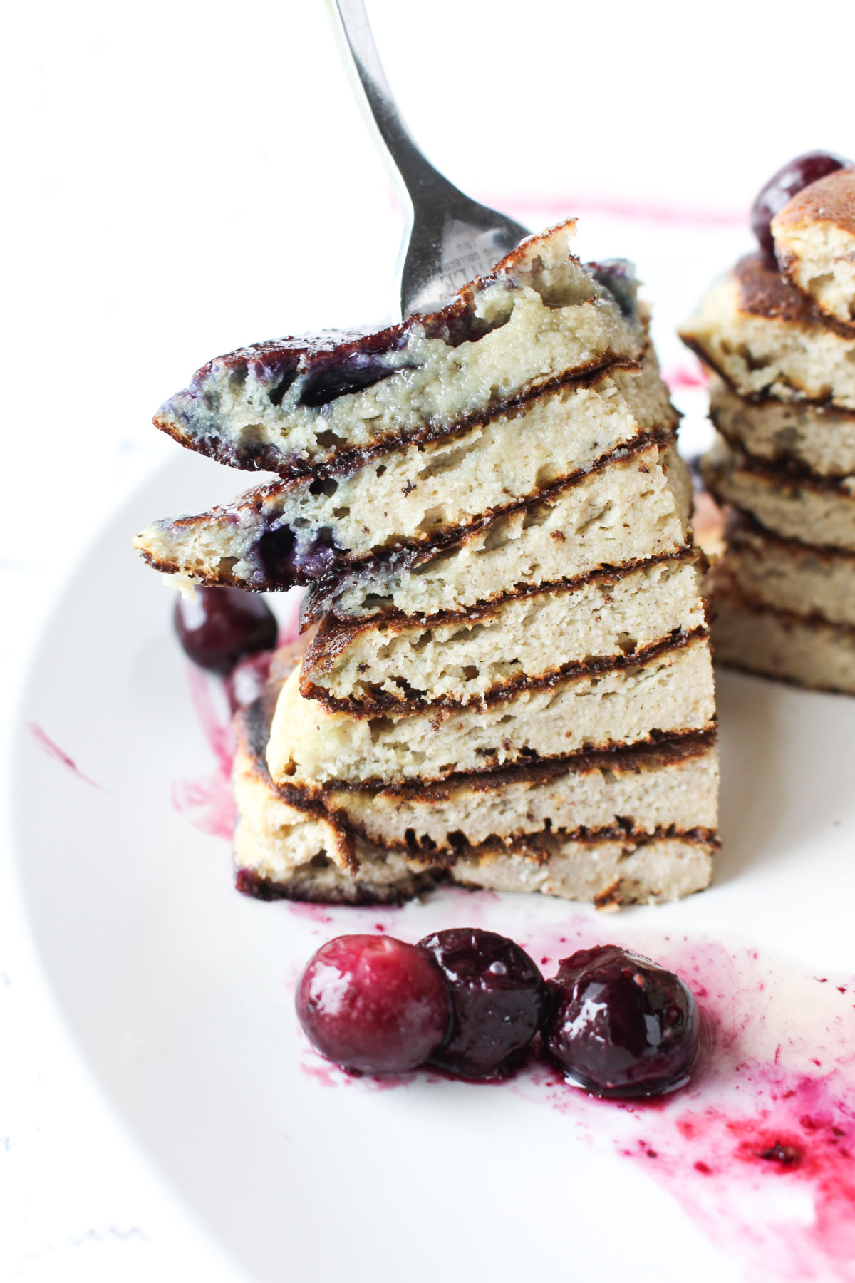 Fork with a huge bite of pancakes.