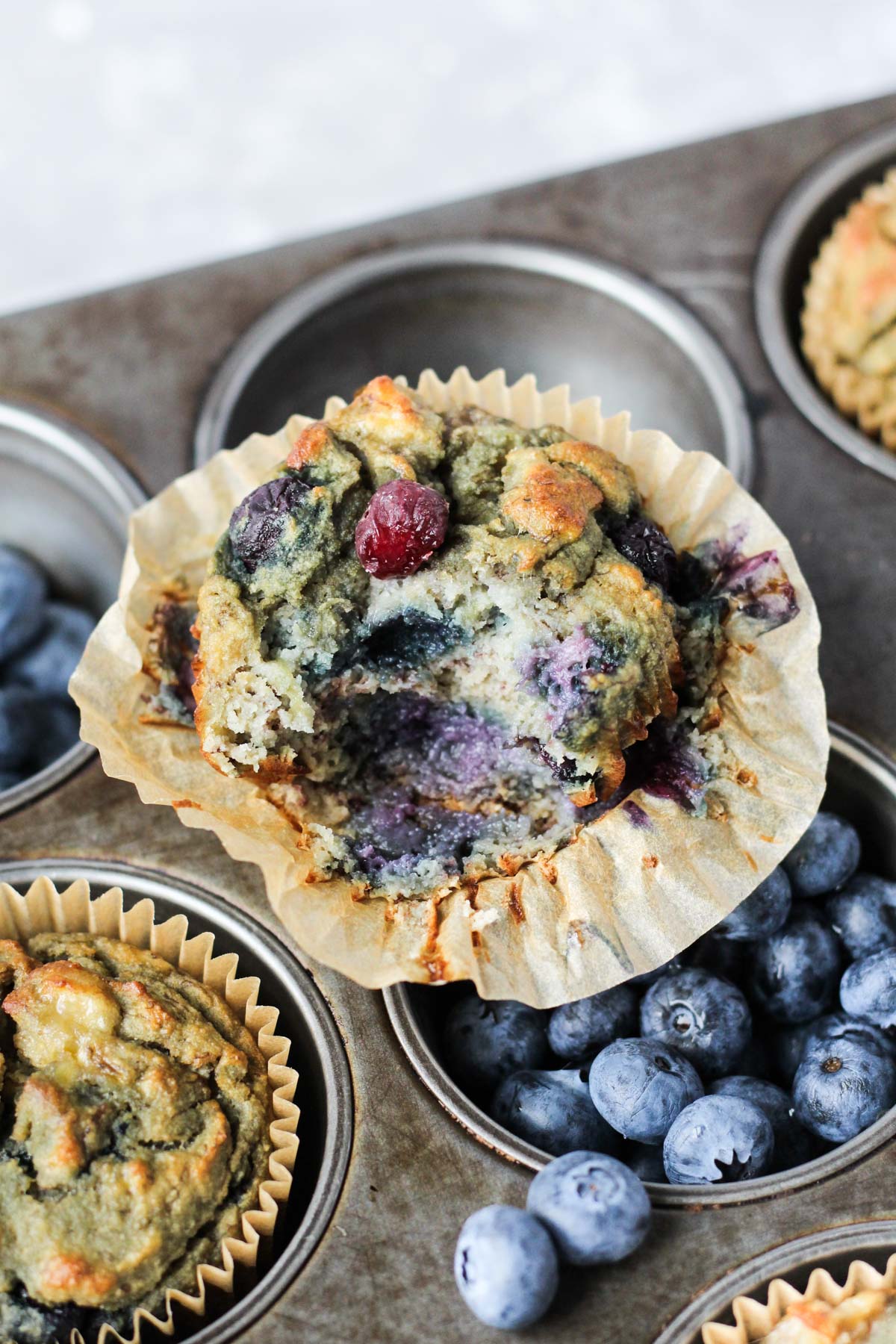 Close up shot of blueberry muffin with a bite taken out.