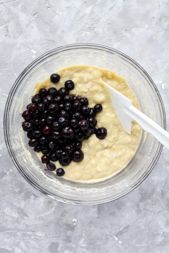 Muffin batter with blueberries on top.