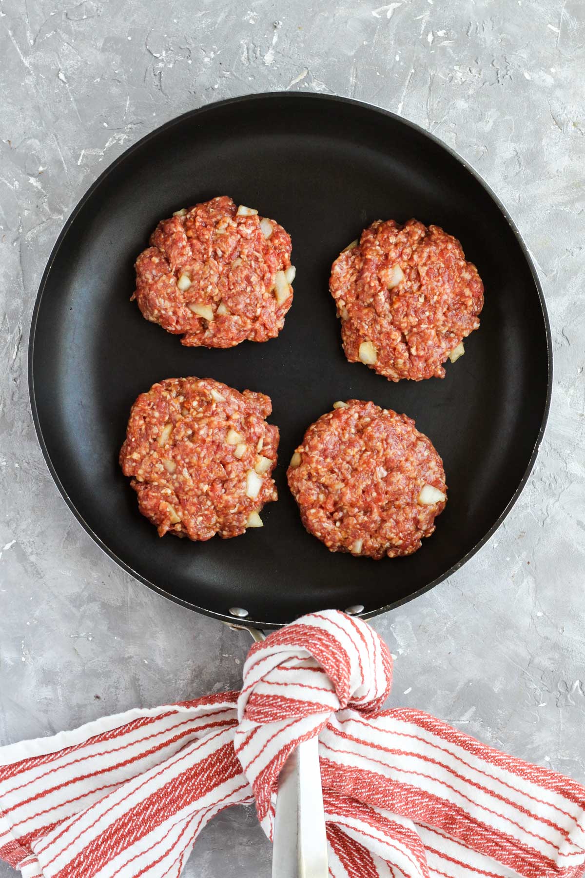 Burgers on non-stick skillet.