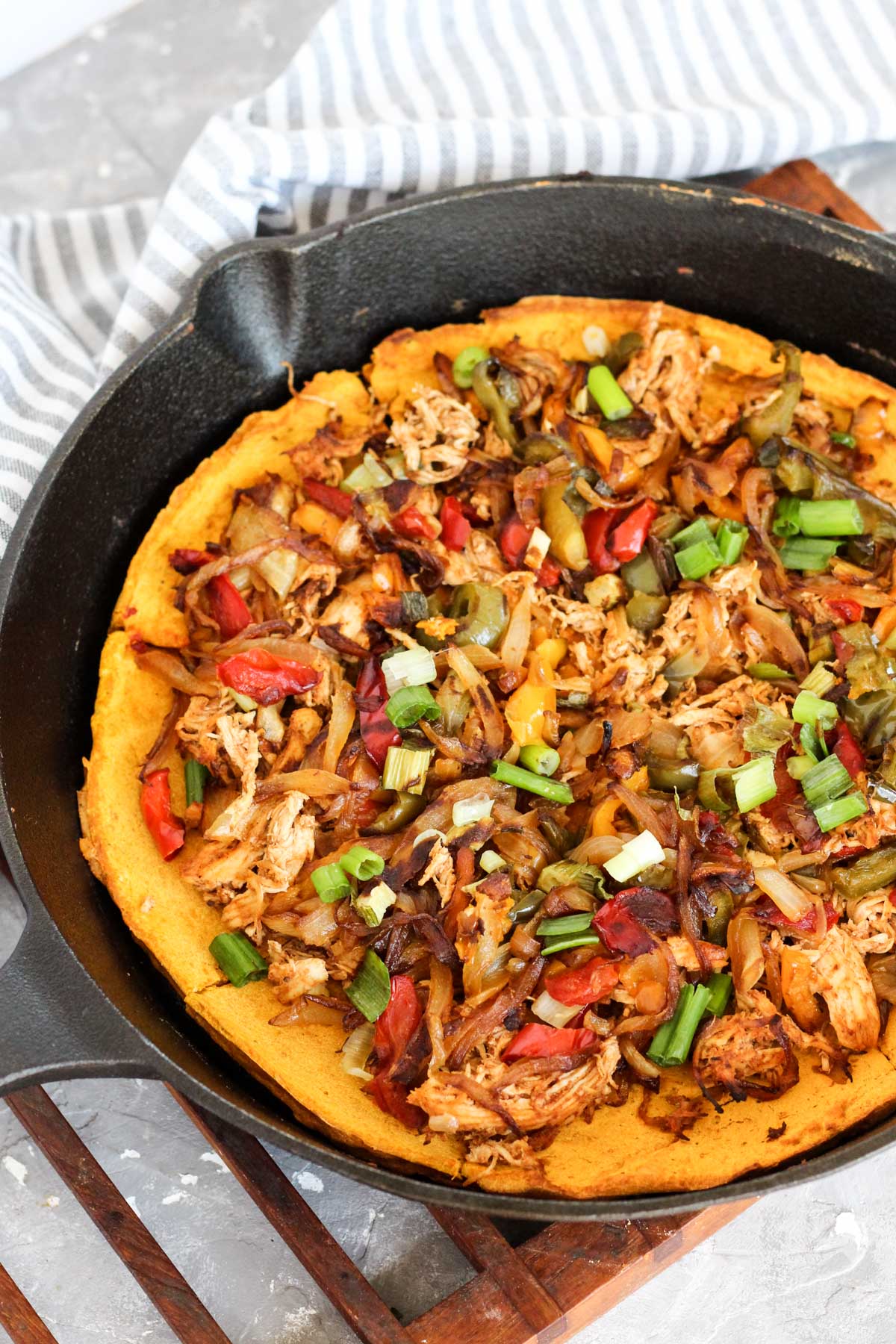 Finished pizza in cast iron skillet.