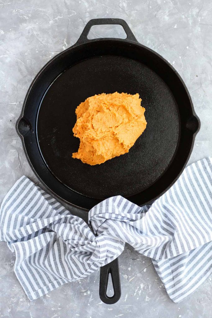 Dough on greased cast iron skillet.