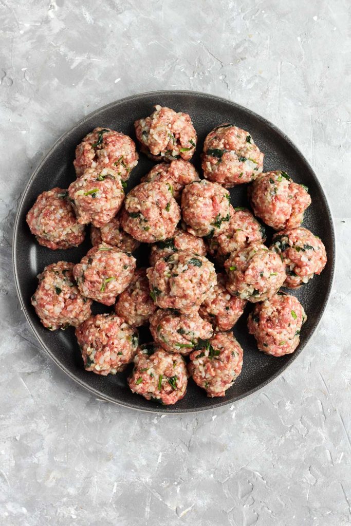 Raw meatballs on a plate.