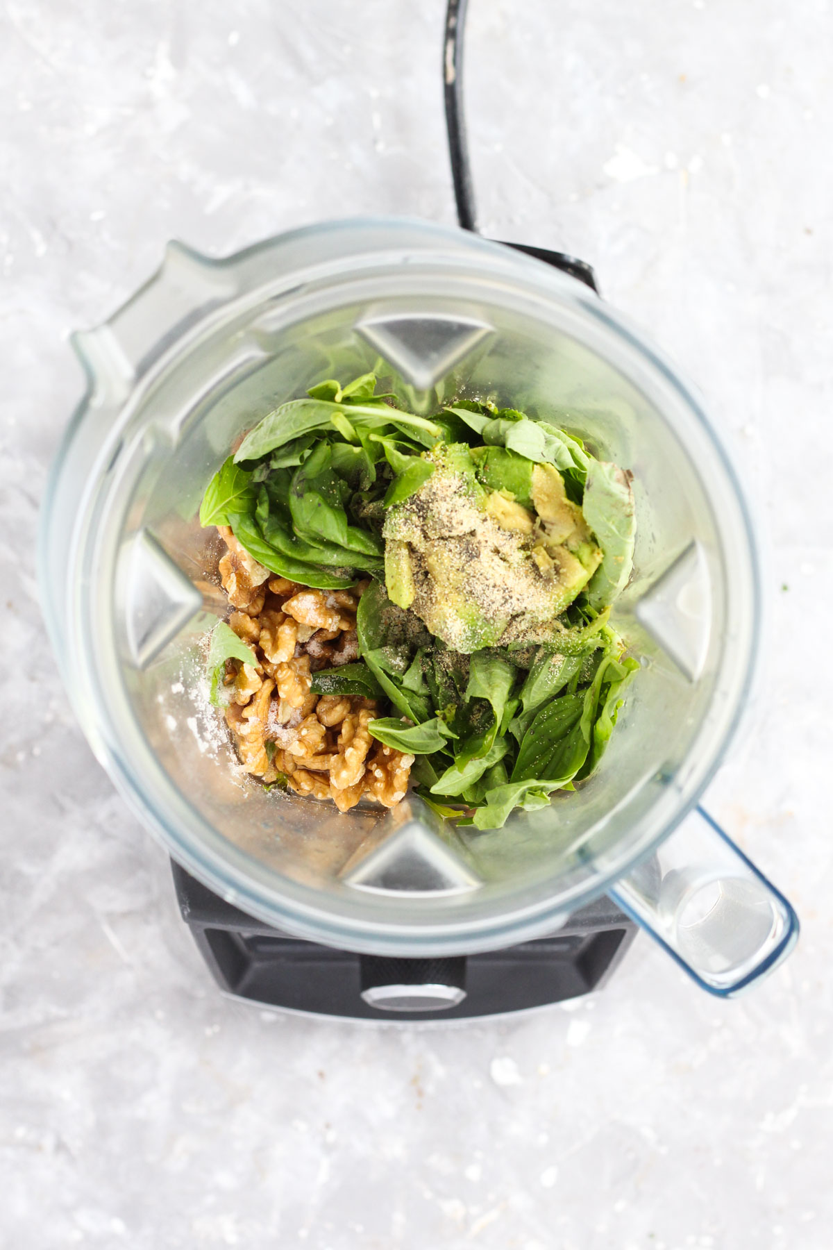 Pesto ingredients in blender.