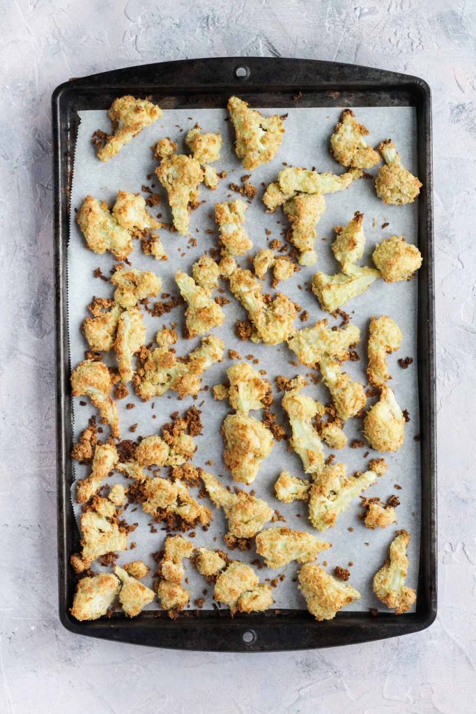 Golden brown cauliflower on baking sheet.