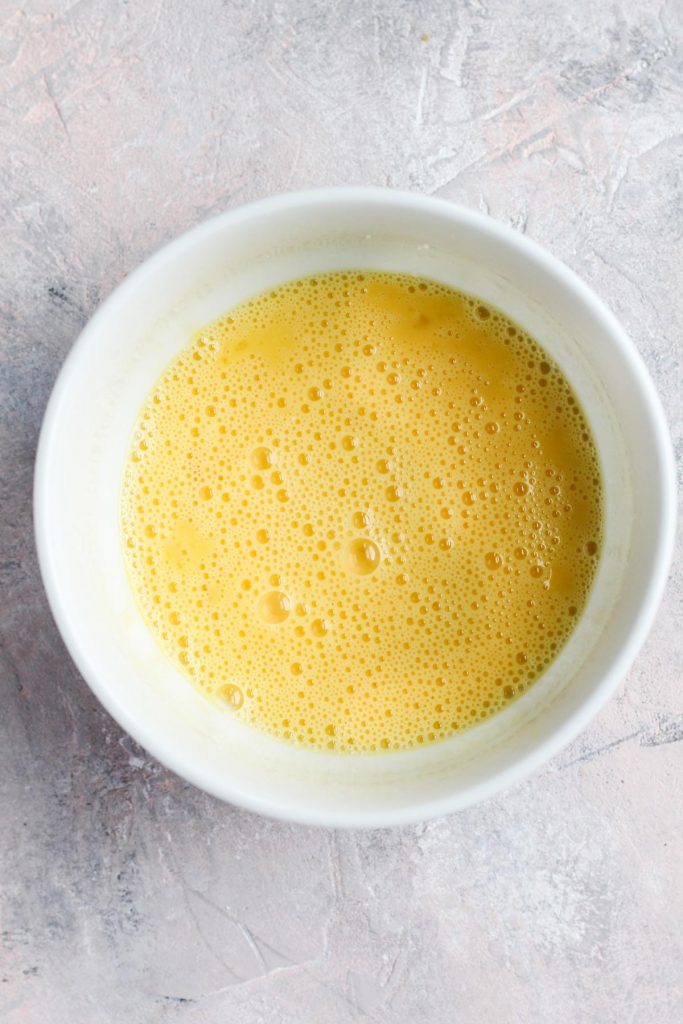 Whipped eggs in mixing bowl.