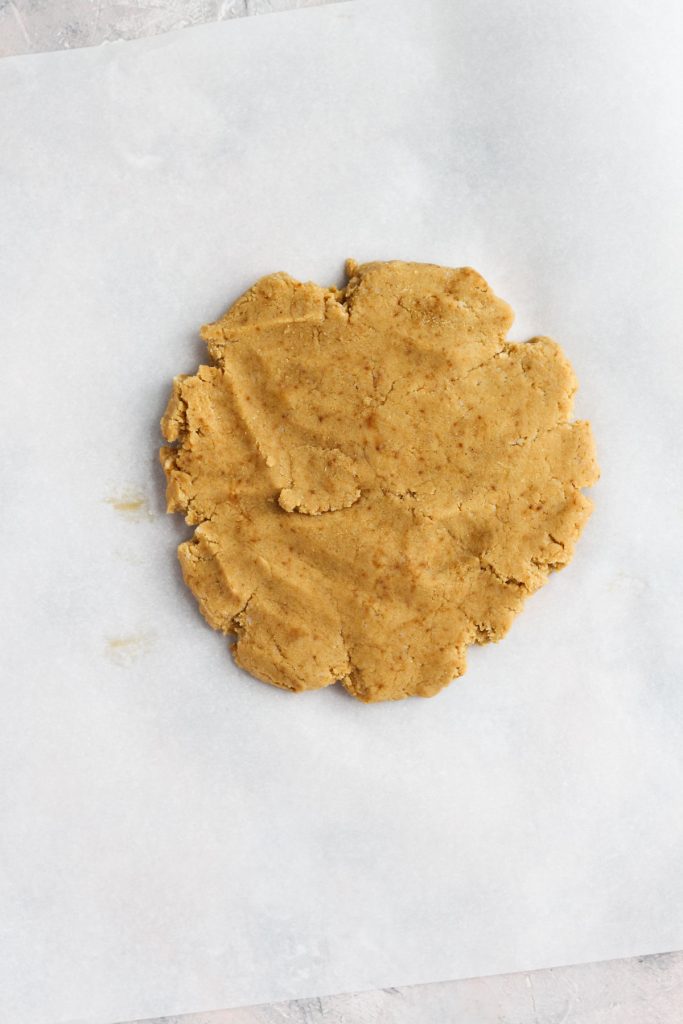 Dough pressed out onto parchment paper.