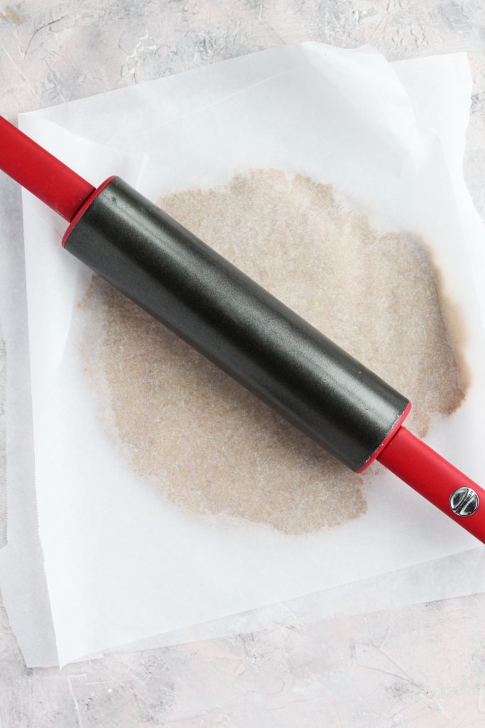 Rolling out dough with rolling pin.