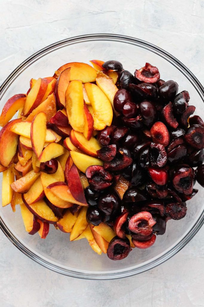 Fruit chopped in glass bowl.