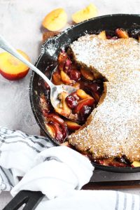 Side angle of cobbler with a spoon scooping out fruit.