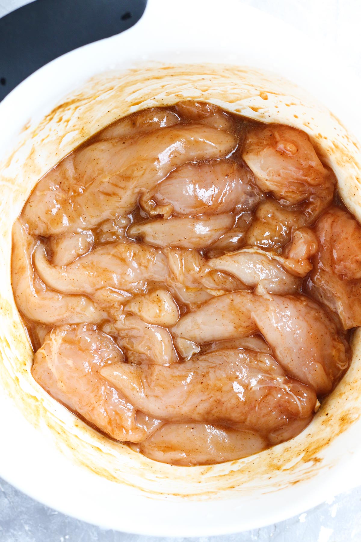 Chipotle chicken marinating in a bowl.