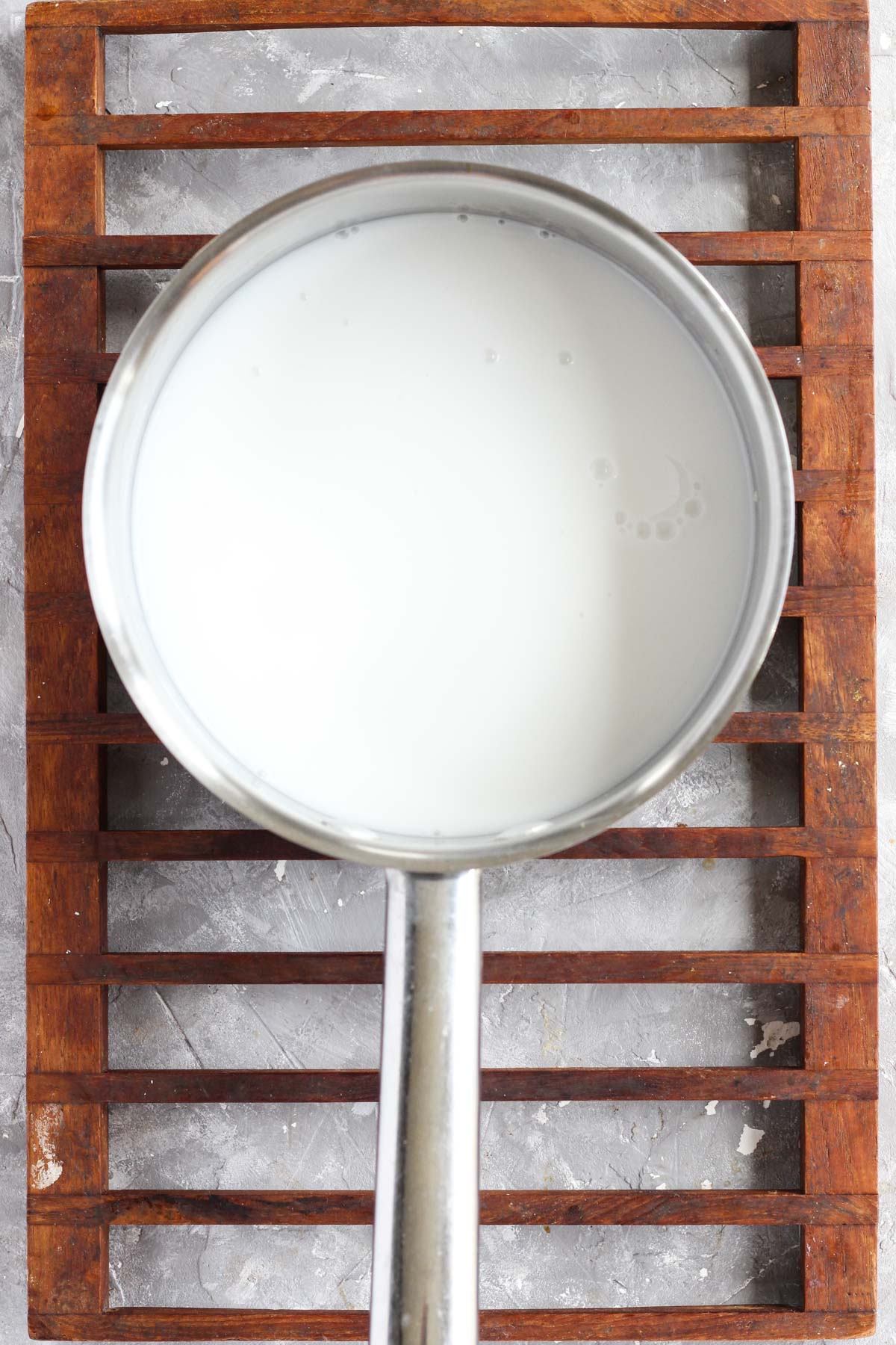 Pot with boiling coconut milk.