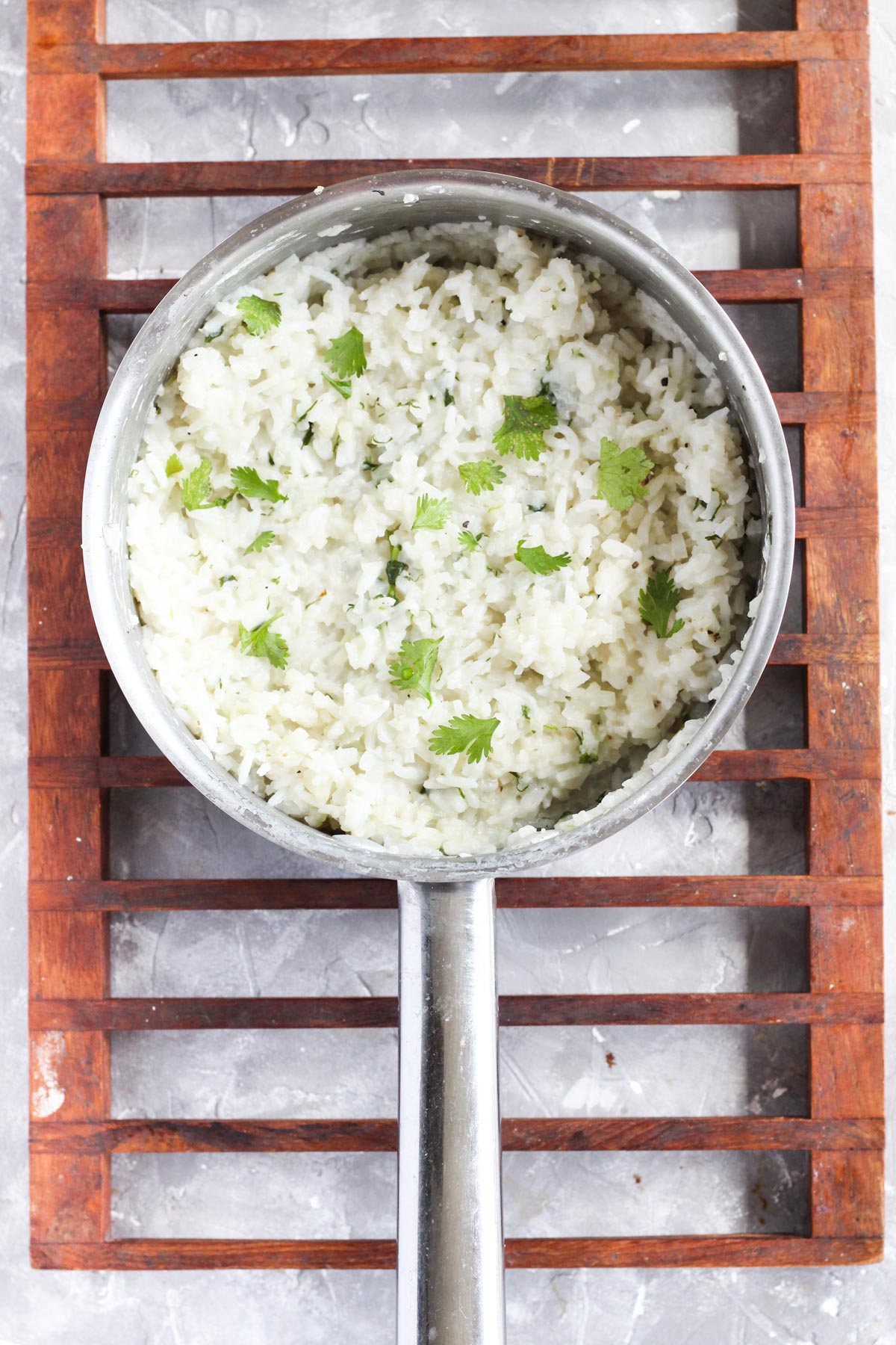 Pot with cooked cilantro rice.