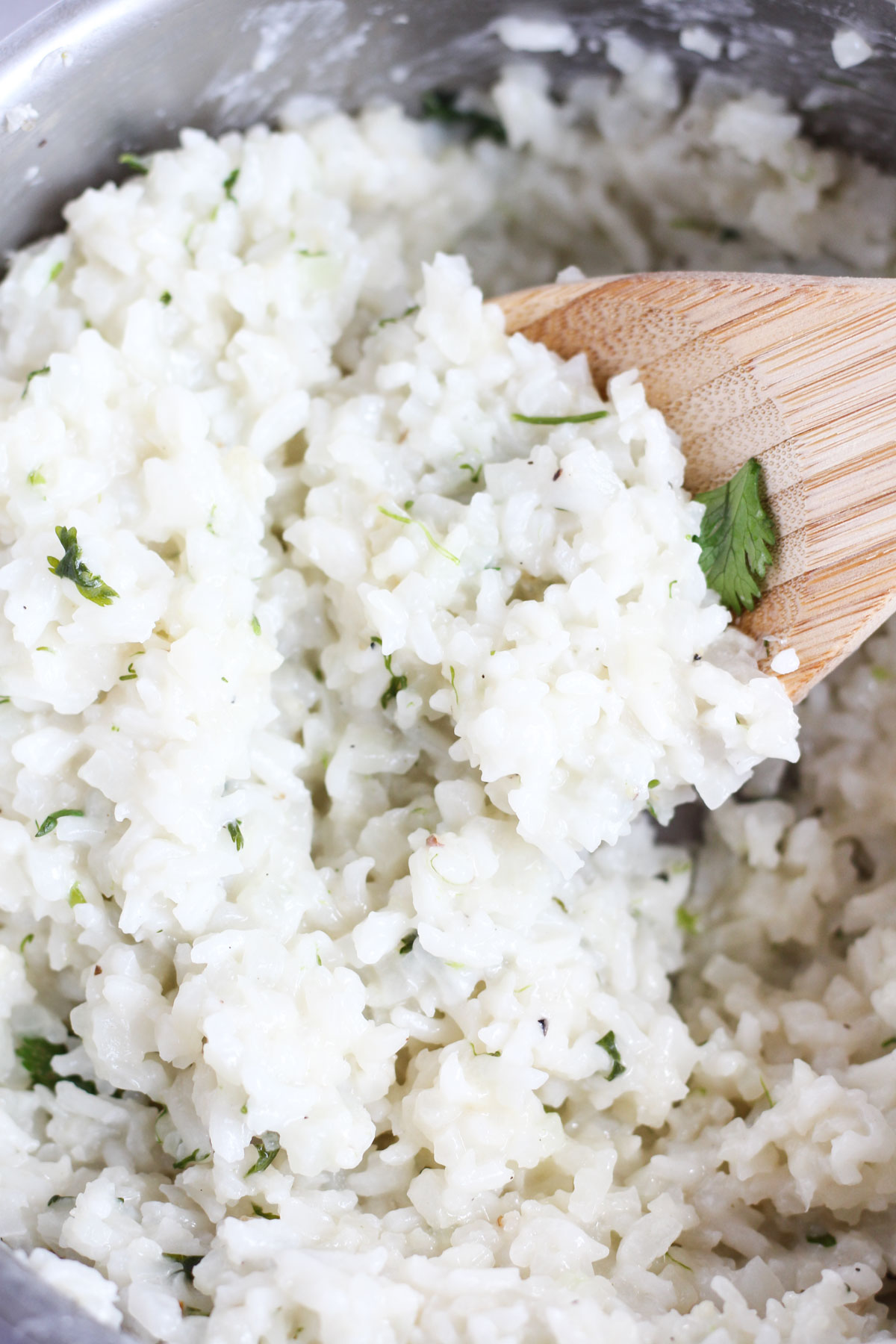 Spoon scooping out cilantro rice.