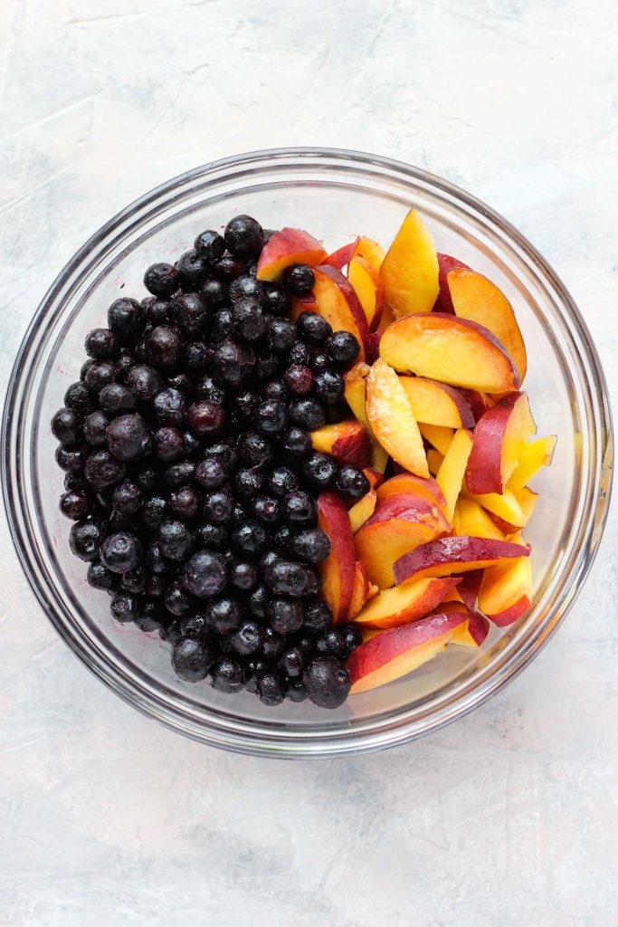 Peaches and blueberries in a bowl.