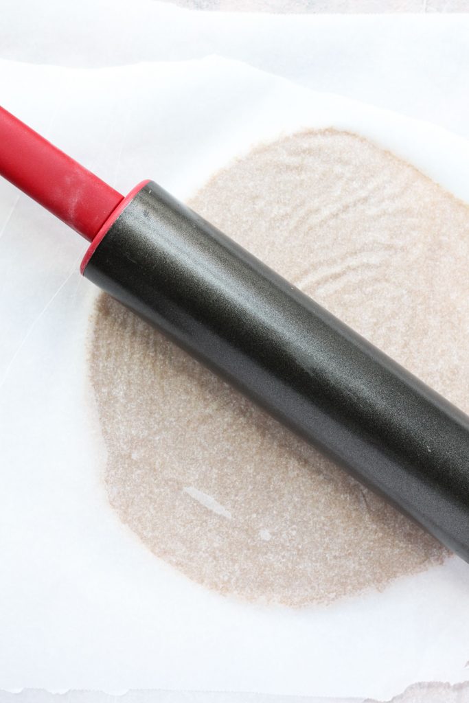 Rolling out pastry dough.