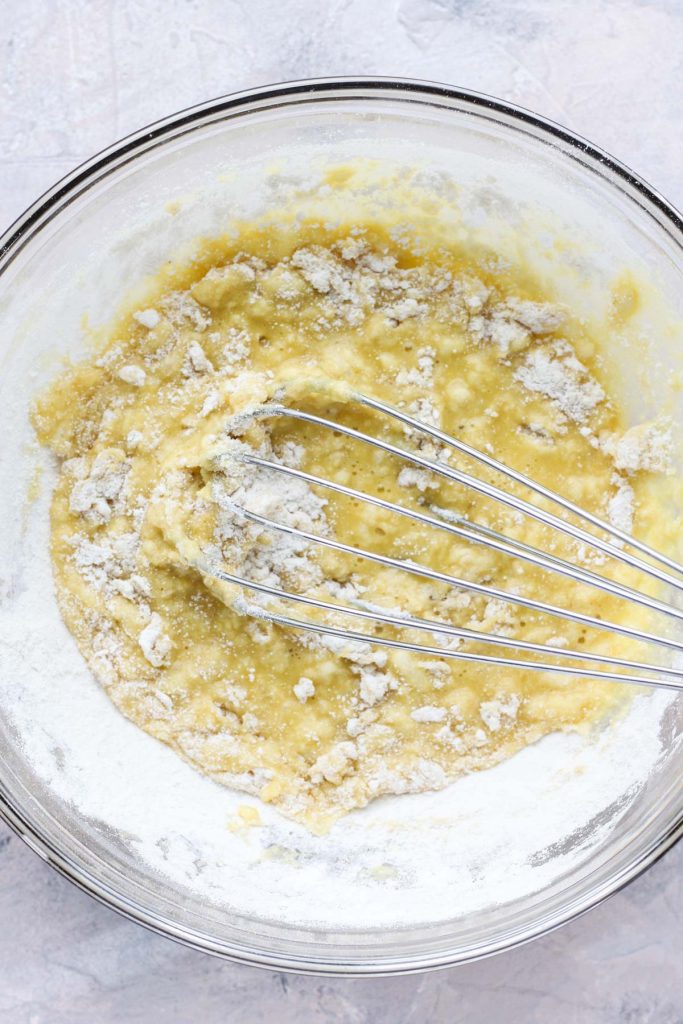 Whisk blending the two mixtures together.