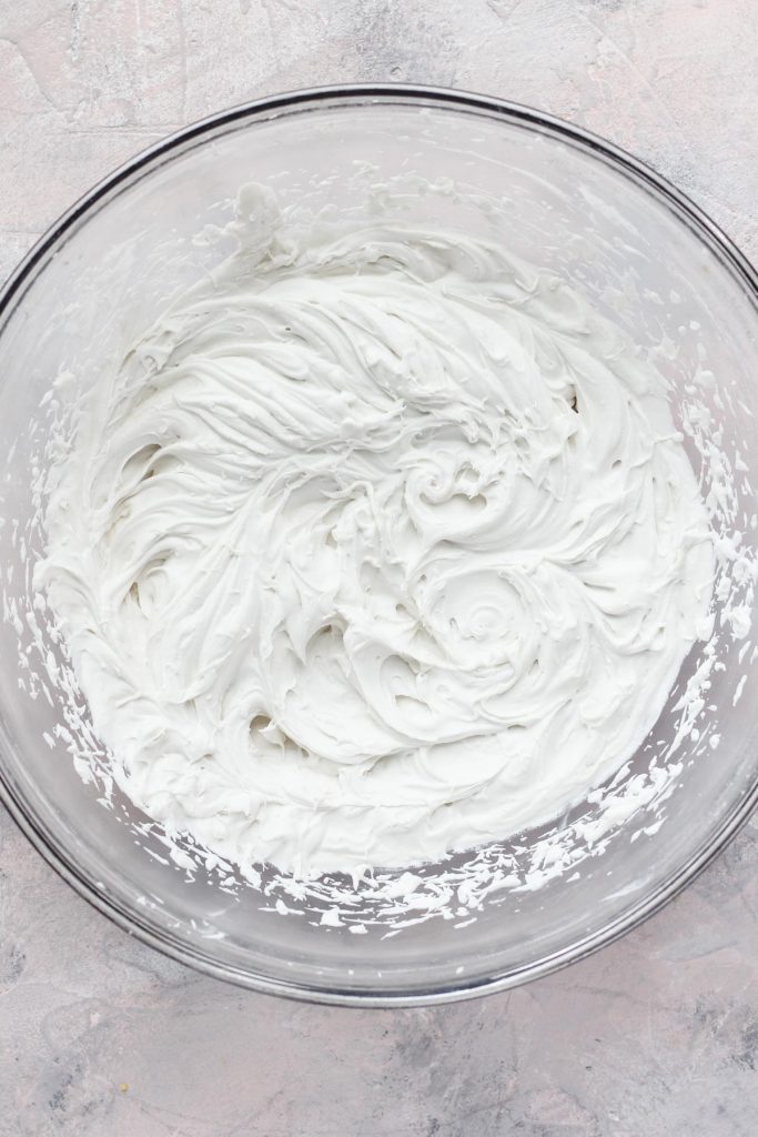 Mixing bowl filled with whipped cream.