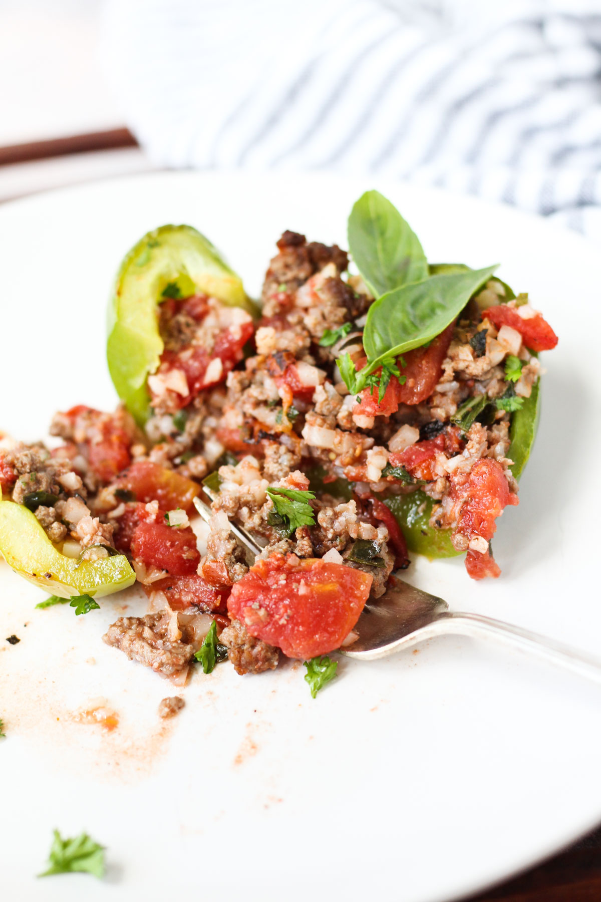 Stuffed pepper on plate with fork.