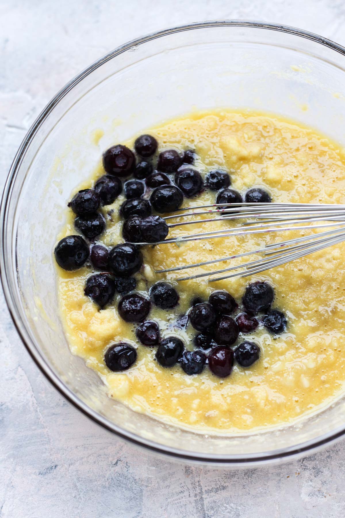 Bowl of pancake mix with blueberries on top.