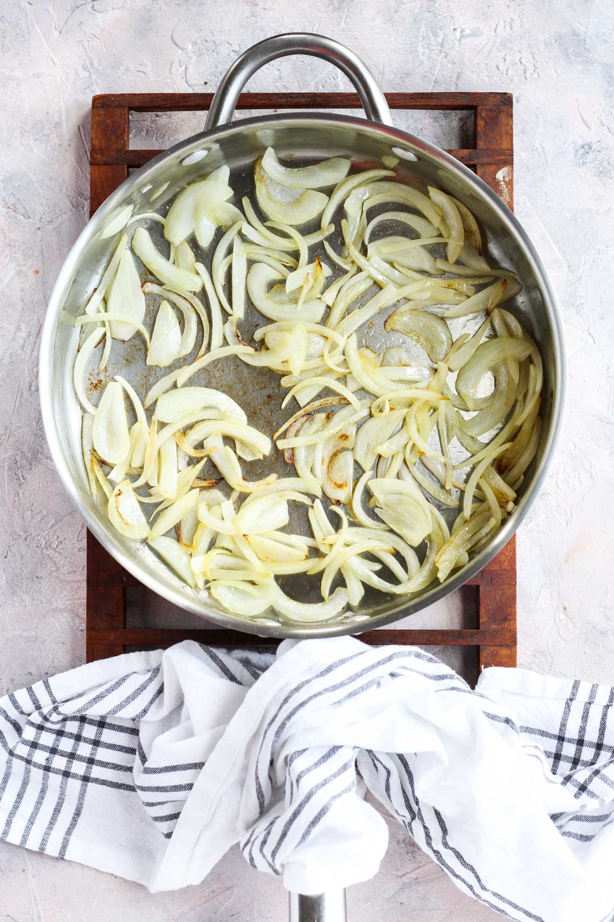 Caramelized onions cooking in a pan.