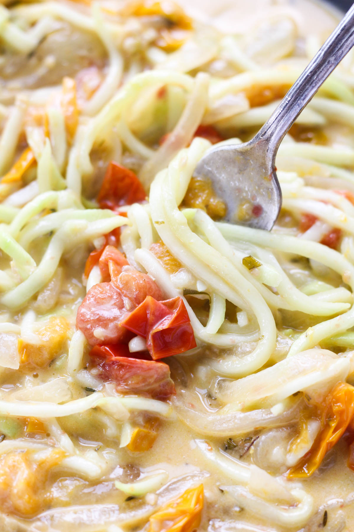 Fork twisting zucchini noodles.