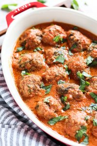 Casserole dish with gluten-free meatballs and sauce.