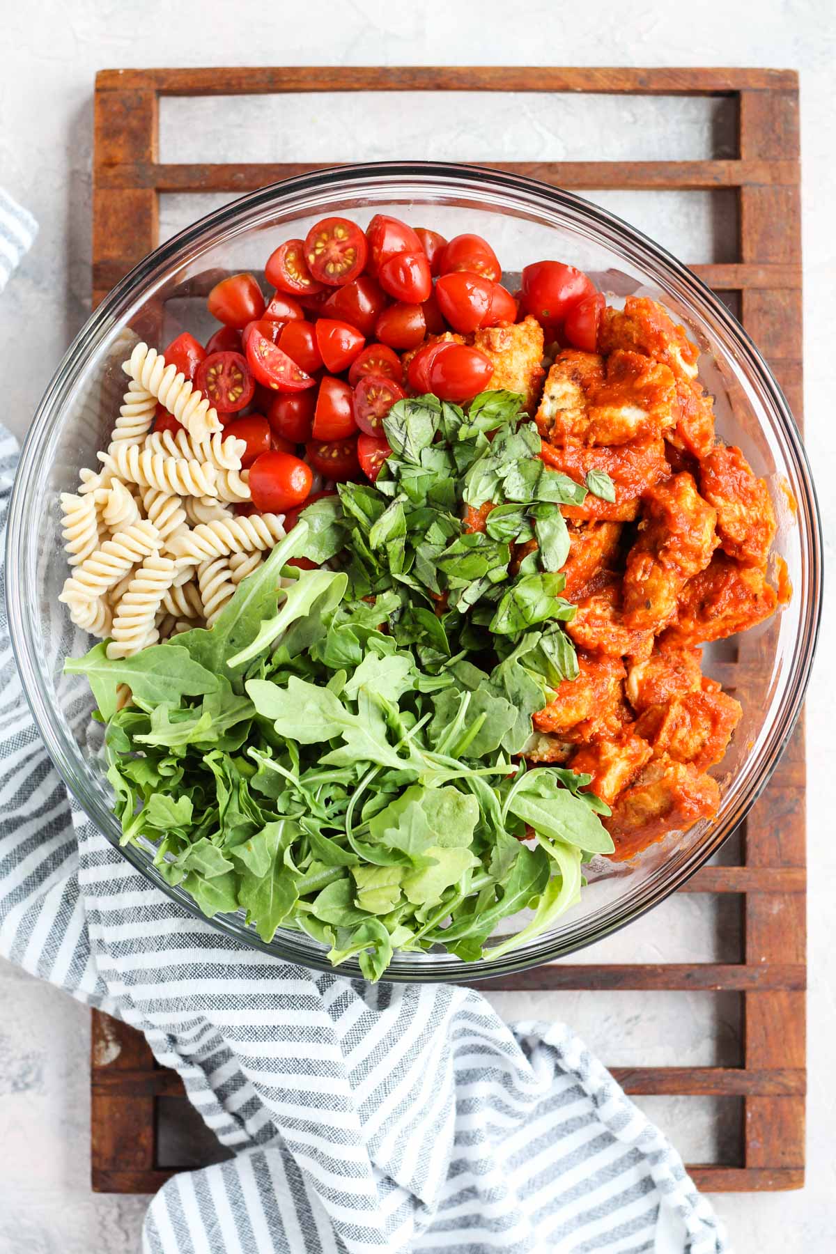 All pasta salad ingredients in a bowl before being mixed up.