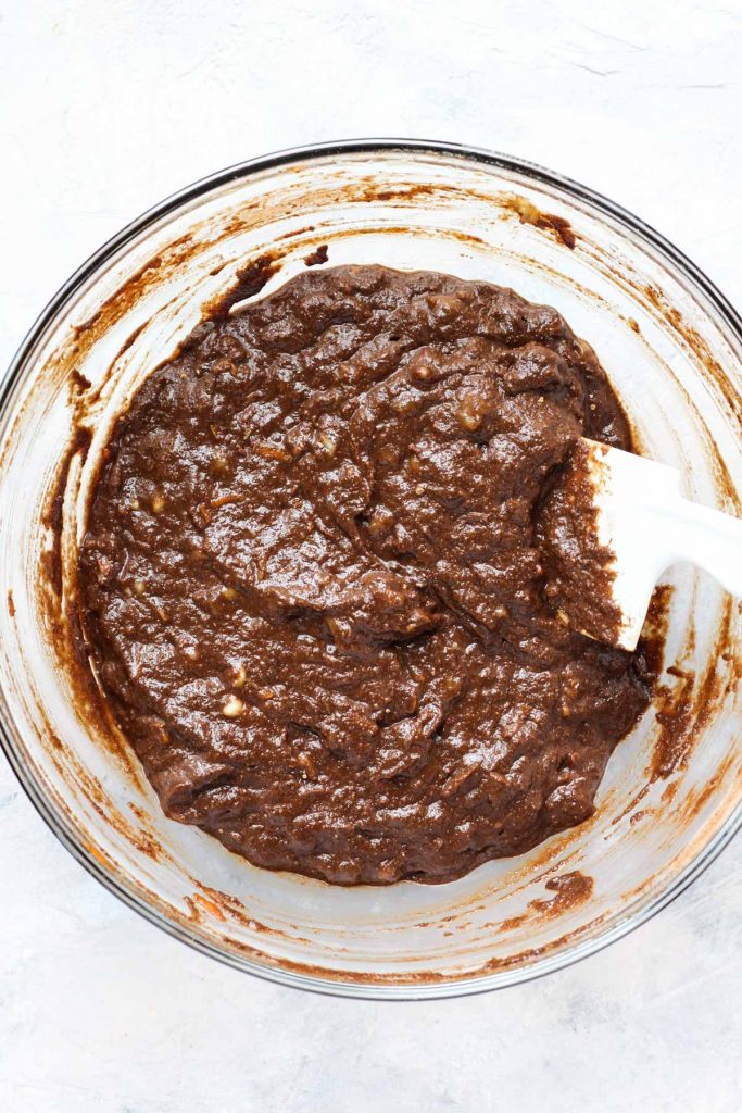 Banana bread batter in a glass bowl.