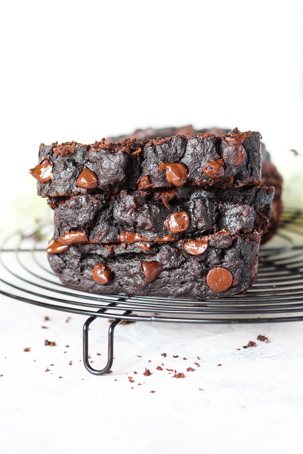 Slices of chocolate banana bread stacked on top of each other.